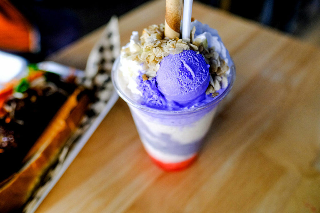 Lasa Sandwiches & Pearls serves halo halo, a Filipino shaved ice dessert layered with pandan rubies, jellies, halaya (purple yam jam), macapuno (coconut strings) and jackfruit, then topped with coconut whip, ube ice cream and leche flan. Halo halo means “mix mix” and is a fruity, creamy, milky, custardy, sweet and crunchy dessert adventure. (Taylor Goebel / The Herald)
