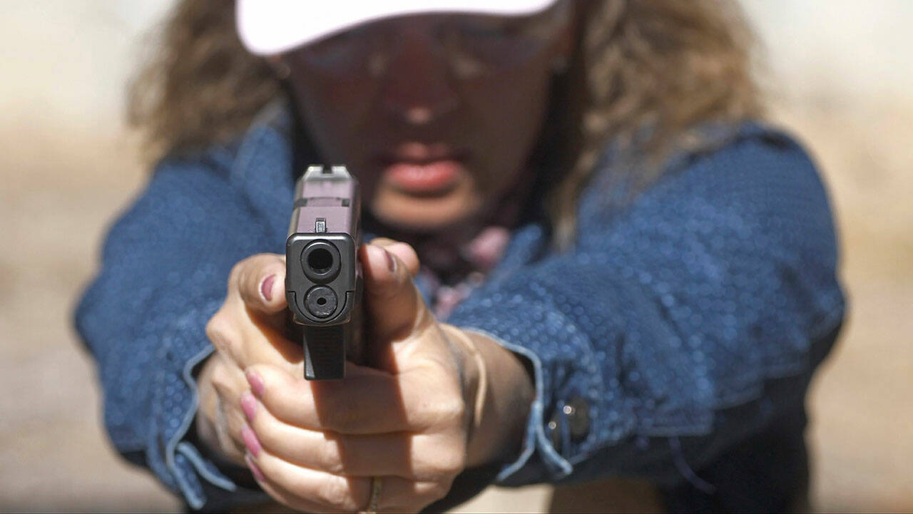 Cindy Bullock, a secretary at Timpanogos Academy, a charter school in Lindon, Utah, participates in shooting drills at the Utah County Sheriff’s Office shooting range during training for teachers and school staff, in Spanish Fork Canyon, Utah, in late June 2019. About 30 teachers in Utah spent their summer learning how to pack wounds and shoot guns as part of training held by police to prepare educators for a mass shooting at their schools. (Rick Bowmer / Associated Press)