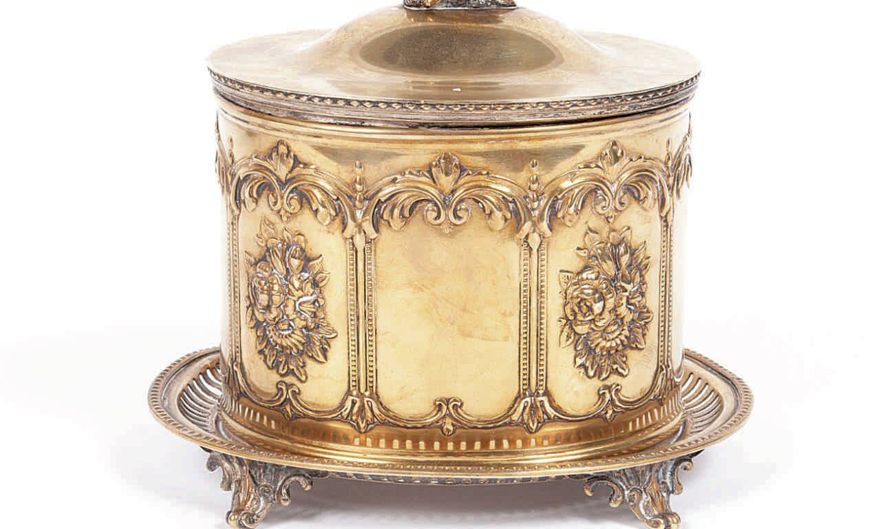 Every food you might find on a Victorian table had its own silver-plated dish. This English silver-plated jar was used for cookies or "bisquits."