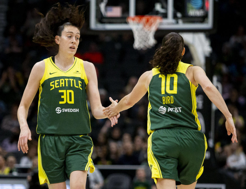 Seattle Storm’s Breanna Stewart high fives Sue Bird after making a three-point shot during the game against the Connecticut Sun on Sunday, June 5, 2022 in Seattle, Washington. (Olivia Vanni / The Herald)
