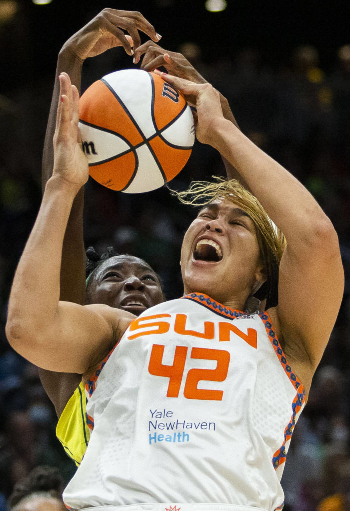 Connecticut Sun’s Brionna Jones yells as Seattle Storm’s Ezi Magbegor reaches over to block the shot during the game on Sunday, June 5, 2022 in Seattle, Washington. (Olivia Vanni / The Herald)
