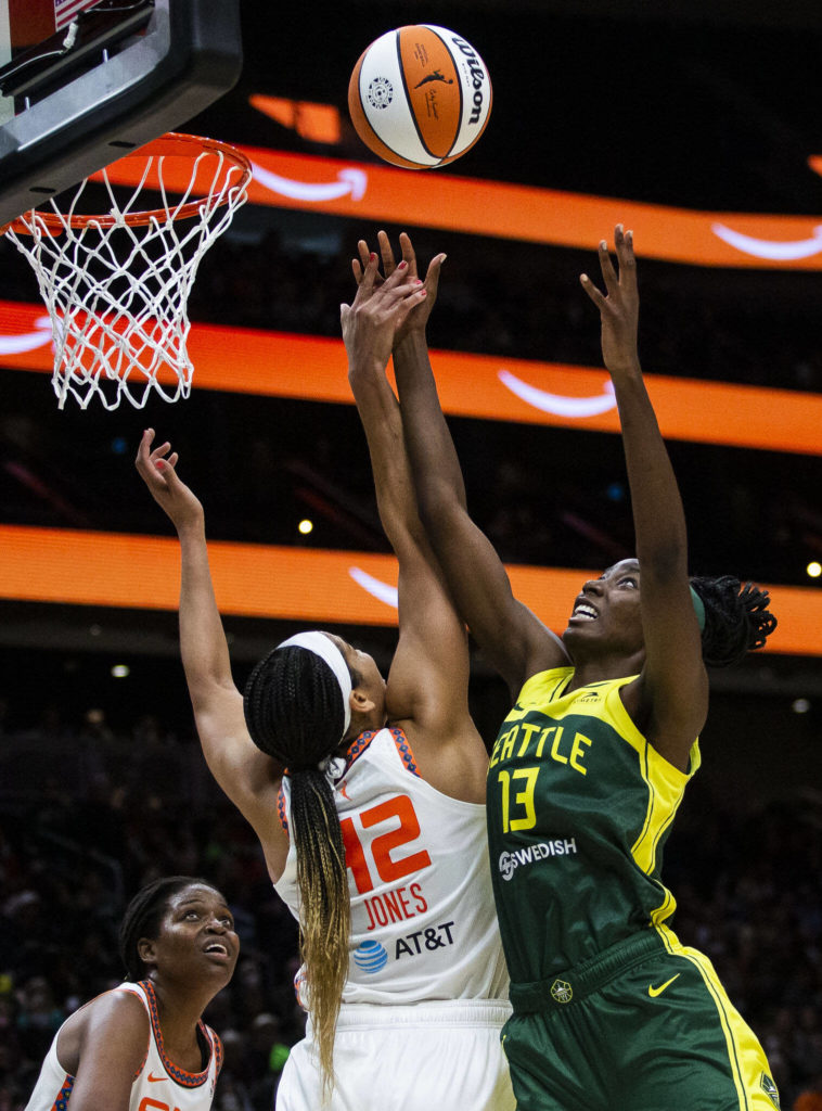Seattle Storm’s Ezi Magbegor jumps for a rebound with Connecticut Sun’s Brionna Jones during the game on Sunday, June 5, 2022 in Seattle, Washington. (Olivia Vanni / The Herald)
