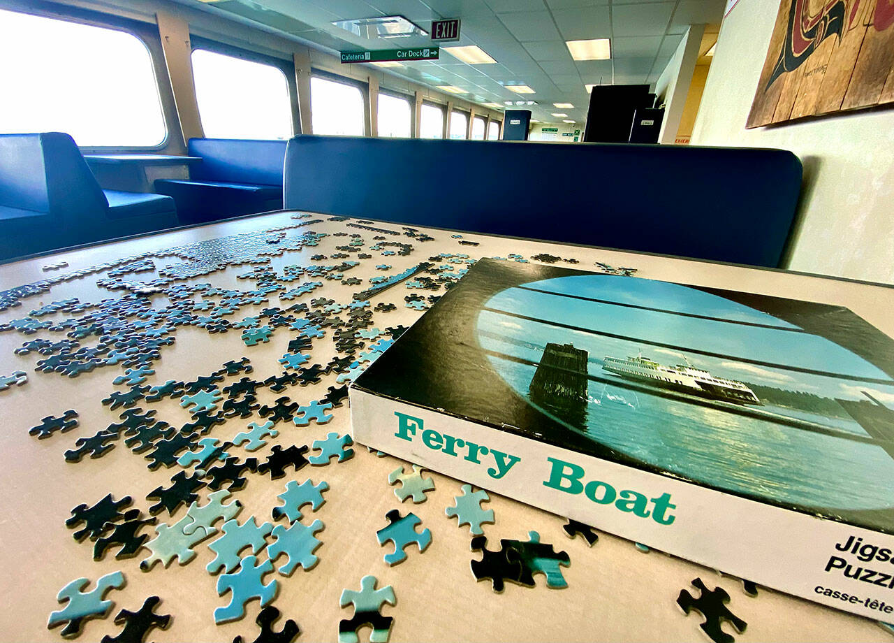 A puzzle is back on a ferry table on the Mukilteo-Clinton route. Community jigsaw puzzles, a popular passenger pastime on most routes, were removed during the pandemic. (Andrea Brown / The Herald)