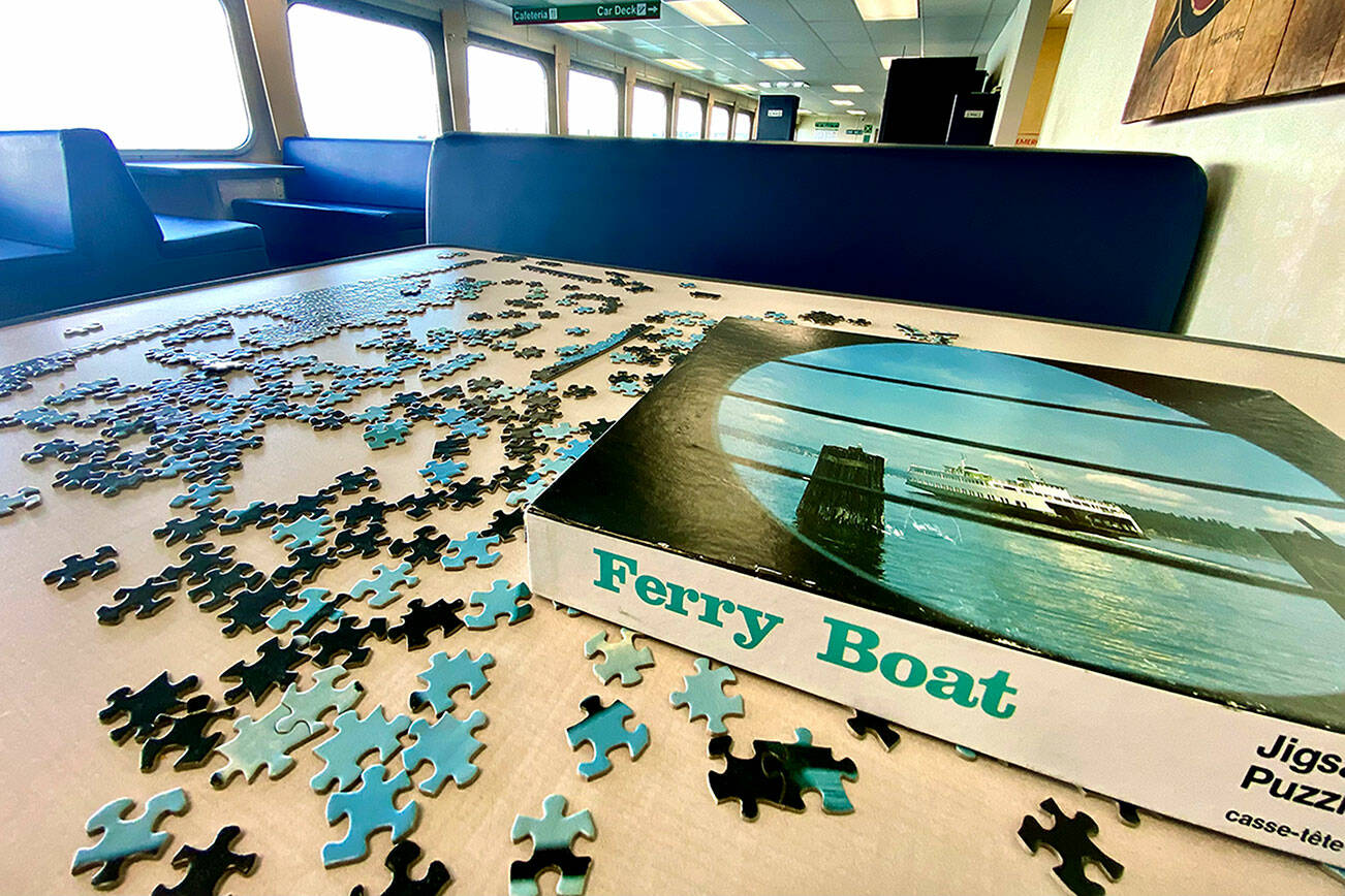 A puzzle is back on a ferry table on the Mukilteo-Clinton route. Community jigsaw puzzles, a passenger pastime on most routes, were removed during COVID. (Andrea Brown / The Herald)