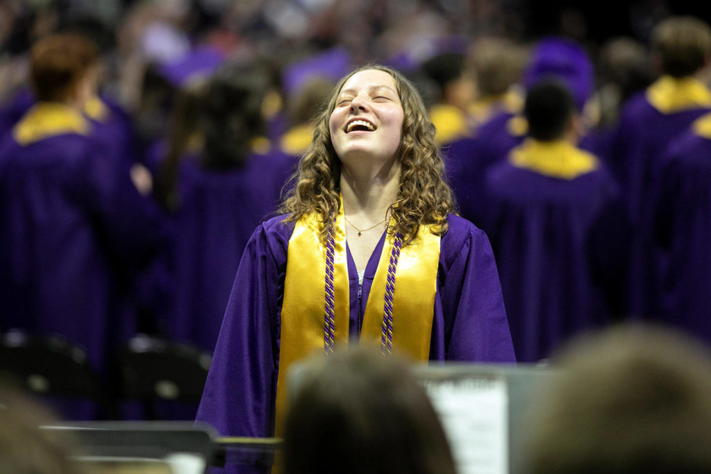 Graduating drum major Holly Balan exhales after completing the “Star Spangled Banner” with her band for the last time during Lake Stevens High School’s 2022 commencement ceremony Tuesday at Angel of the Winds Arena in Everett. (Ryan Berry / The Herald) 
