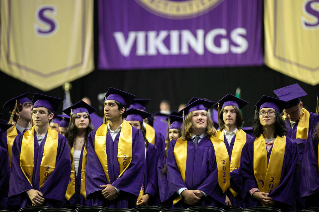 Students look at the crowd during the processional at Lake Stevens High School’s 2022 commencement ceremony Tuesday at Angel of the Winds Arena in Everett. (Ryan Berry / The Herald)
