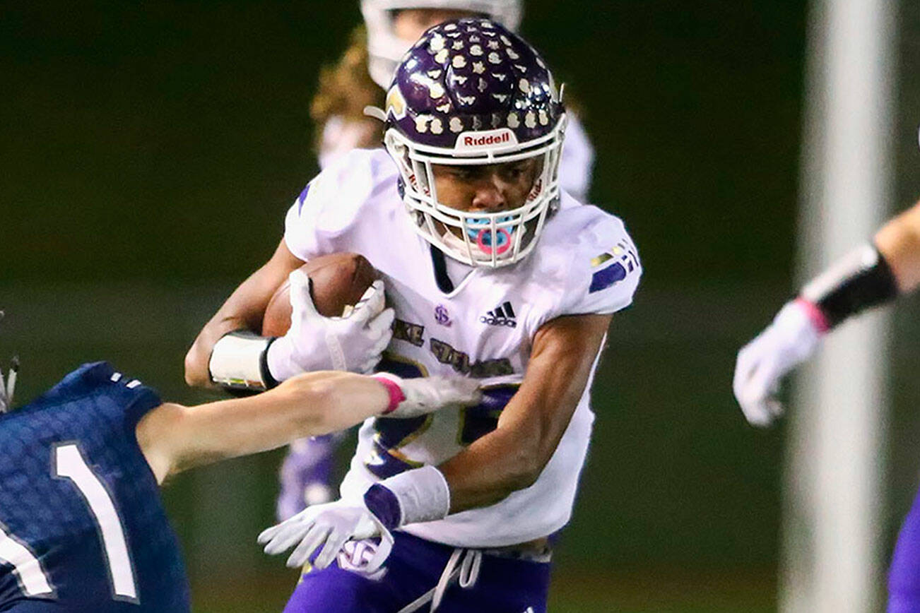 Lake Stevens' Kasen Kinchen dodges a tackle attempt by Glacier Peak's Jadon Claps Friday night at Veterans Memorial Stadium in Snohomish on October 11, 2019. (Kevin Clark / The Herald)