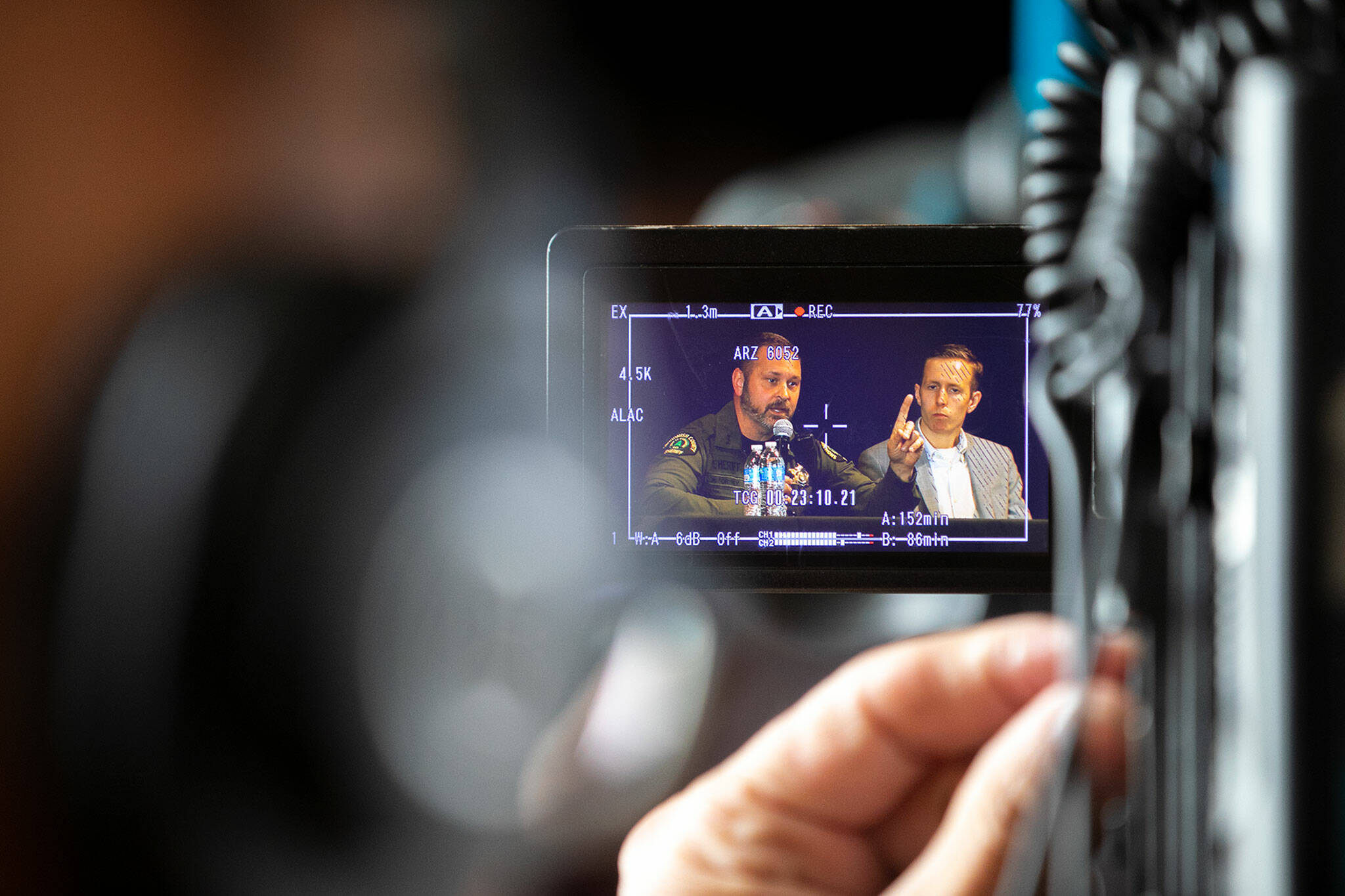 A camera crew records Sheriff Adam Fortney during a public safety town hall meeting Wednesday at the Marysville Opera House in Marysville. (Ryan Berry / The Herald)