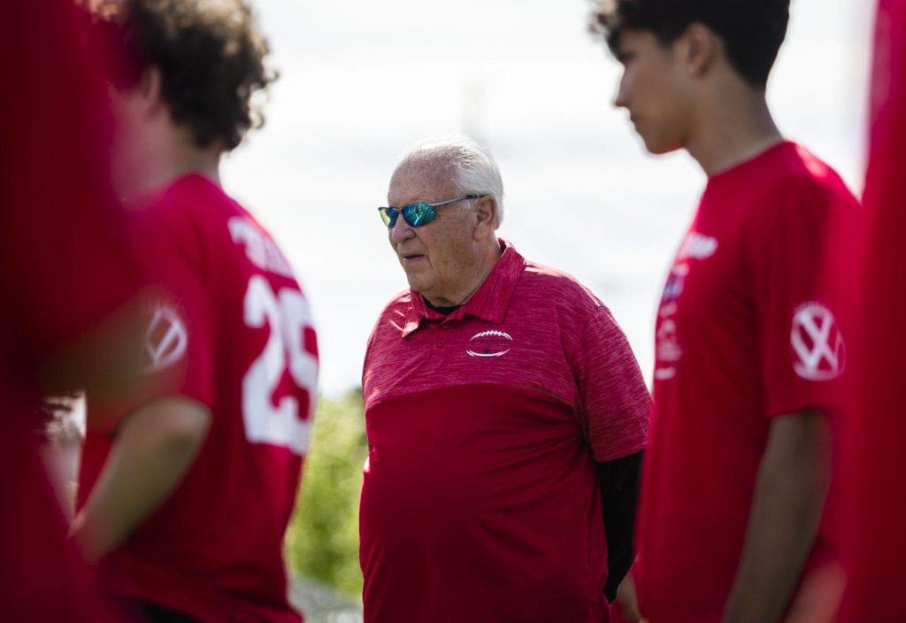 Mike Price watches players run through drills on Wednesday in Everett. (Olivia Vanni / The Herald)
