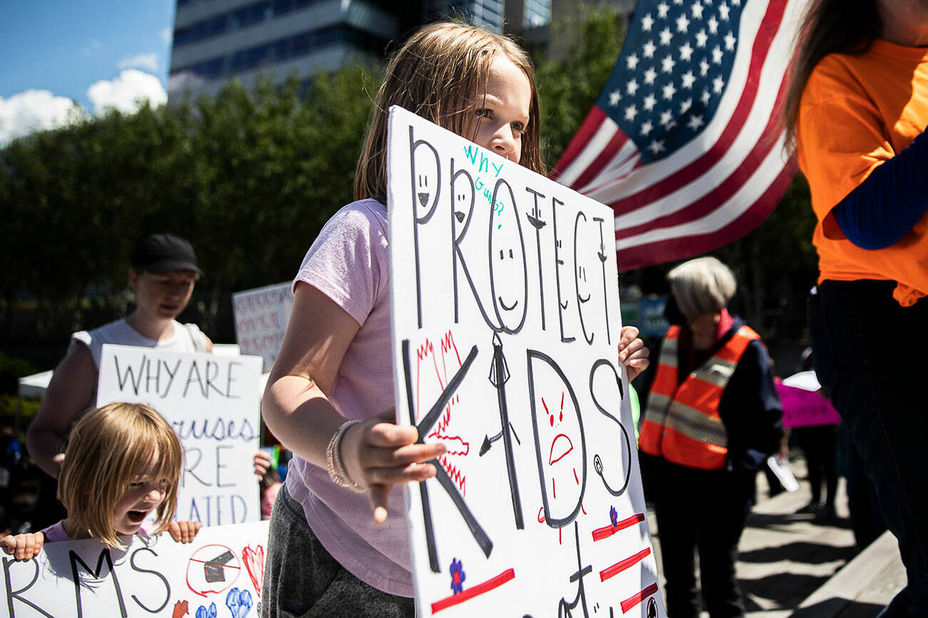 Flo Tremper, 8, who is currently a second grader, helps lead the start of the March For Our Lives out of Snohomish County Courthouse Plaza on Saturday, June 11, 2022 in Everett, Washington. (Olivia Vanni / The Herald)