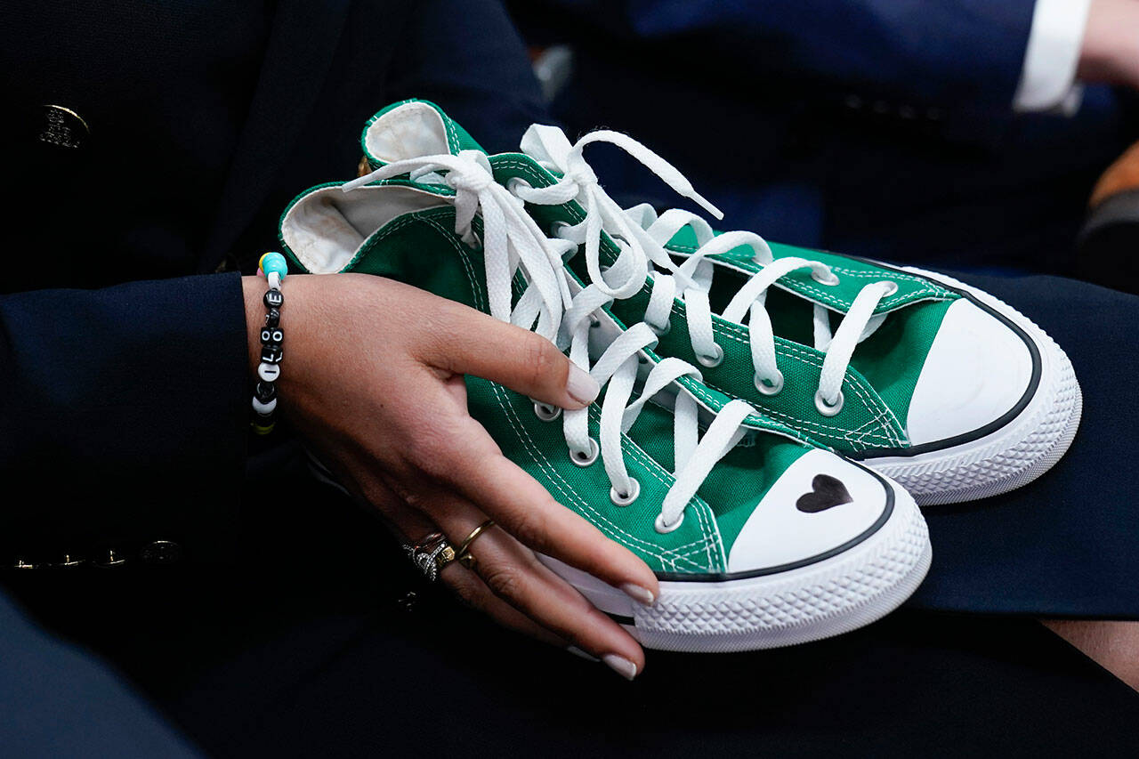 Camila Alves McConaughey holds a pair of green Converse tennis shoes similar to those worn by Uvalde shooting victim Maite Yuleana Rodriguez, 10, as her husband Matthew McConaughey, a native of Uvalde, Texas, joins White House press secretary Karine Jean-Pierre for the daily briefing at the White House in Washington, D.C., June 7. Because of the injuries to Maite’s body, McConaughey said, her identity was confirmed by her green shoes. (Susan Walsh / Associated Press)