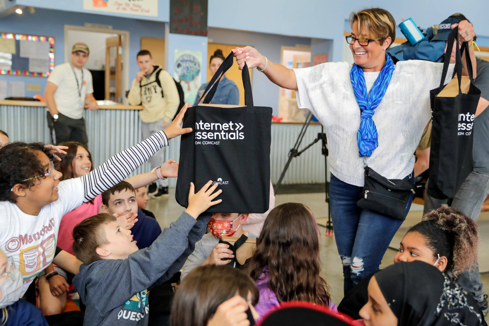 Cassie Franklin, mayor of Everett, hands out laptops to kids at the South Everett/Mukilteo Boys & Girls Club in Everett on Wednesday morning. The laptops are part of Comcast Digital Equity Initiative that will give away 400 laptops.(Kevin Clark / The Herald)