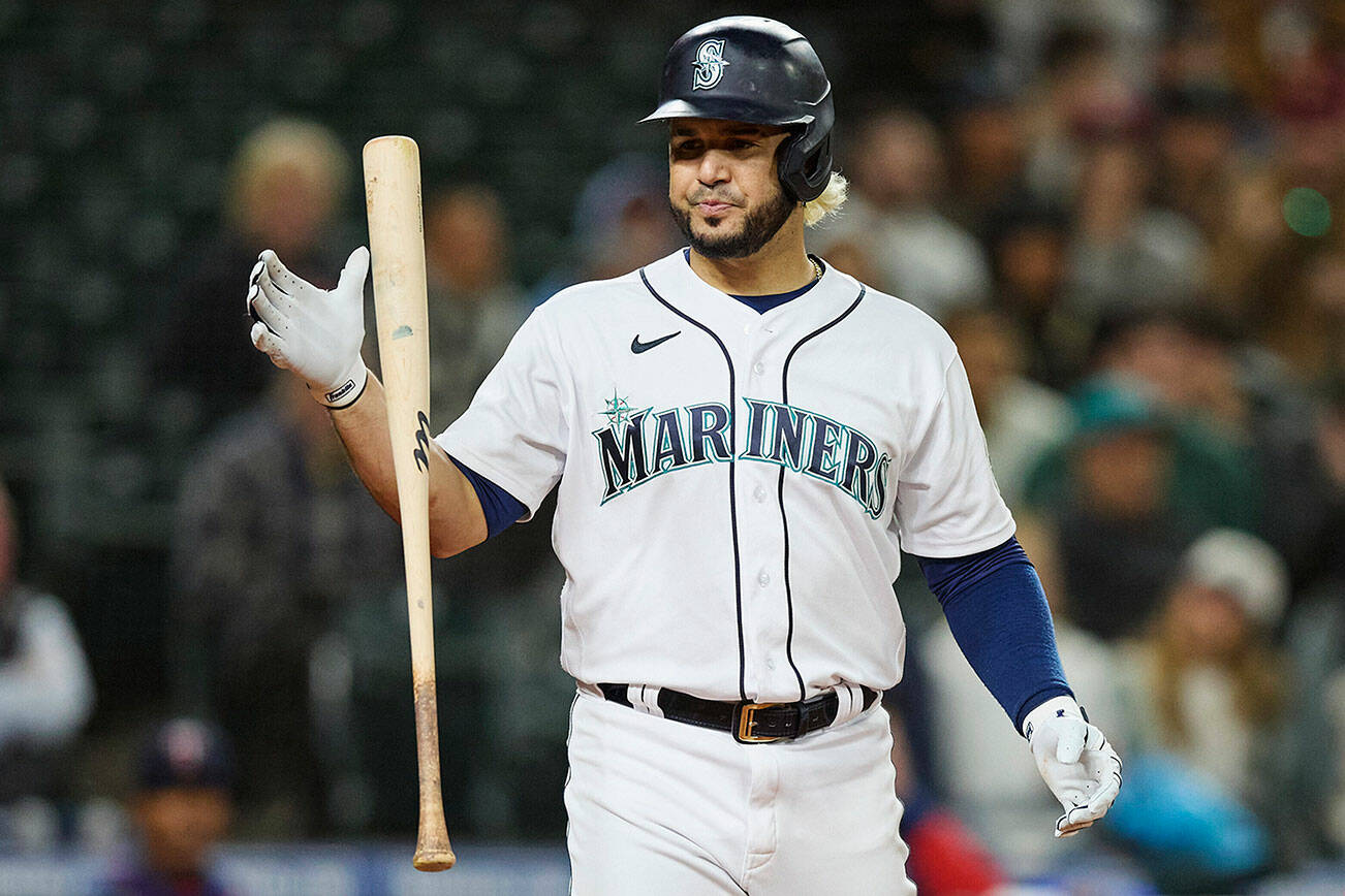 Seattle Mariners' Eugenio Suarez strikes out against the Minnesota Twins during the eighth inning a baseball game, Monday, June 13, 2022, in Seattle. The Twins won 3-2. (AP Photo/John Froschauer)