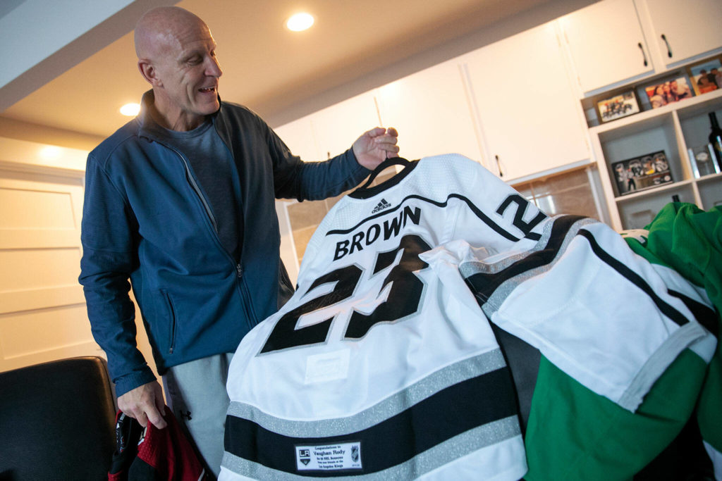 Vaughan Rody shows off two jerseys he plans to display in his home — those of Dustin Brown and Jamie Benn, both of whom Rody said he regarded highly — on June 6 at his home in Lake Stevens. (Ryan Berry / The Herald)
