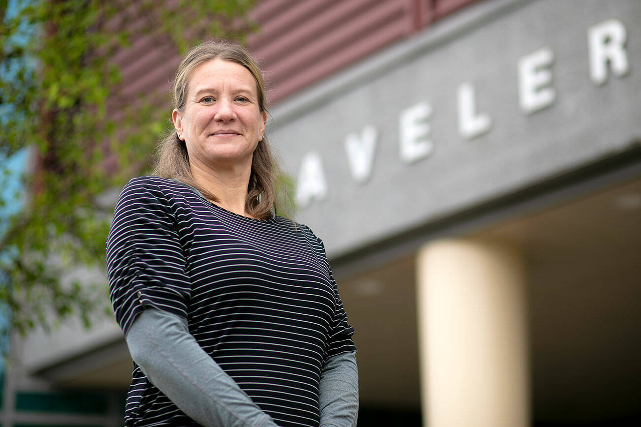 Emily Dykstra, an 8th grade English teacher at Cavelero Mid High School, stands in front of the school on the final day of classes Wednesday, June 15, 2022, in Lake Stevens, Washington. Dykstra will be headed to Poland at the end of June to further her education on the Holocaust, which she intends to use to help teach her students about the subject. (Ryan Berry / The Herald)