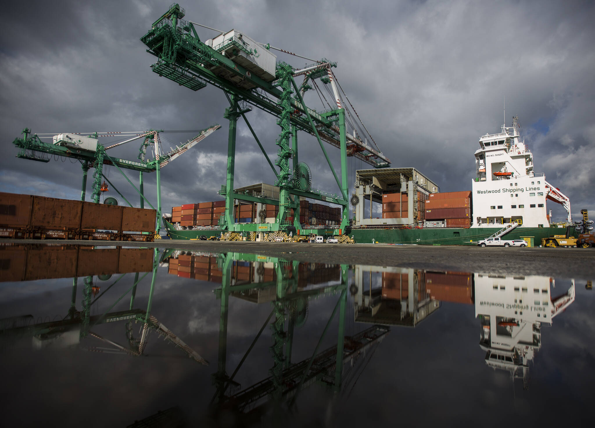 The 214-foot tall cranes work to unload their first cargo shipments at South Terminal at the Port of Everett on April 8, 2021 in Everett. (Olivia Vanni / The Herald)