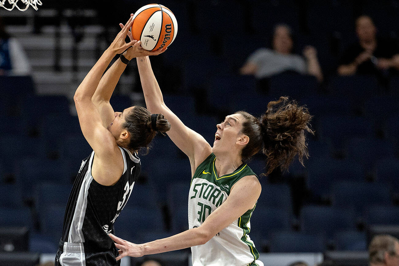 Minnesota Lynx's Nikolina Milic (31) is fouled by Seattle Storm's Breanna Stewart (30) during the first quarter of a WNBA basketball game Tuesday, June 14, 2022, in Minneapolis. (Carlos Gonzalez/Star Tribune via AP)