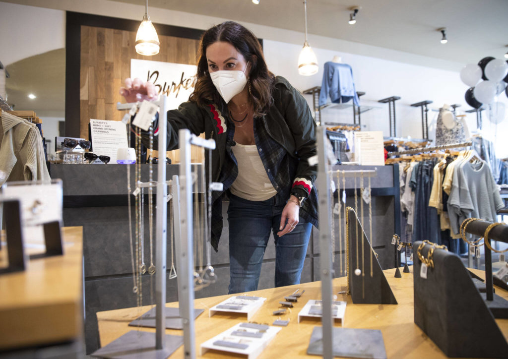 Lisa Richardt, the owner and creator of Veronica & Harold jewelry, adjusts her display inside Burkett’s Home & Gift on Friday in Everett. (Olivia Vanni / The Herald)
