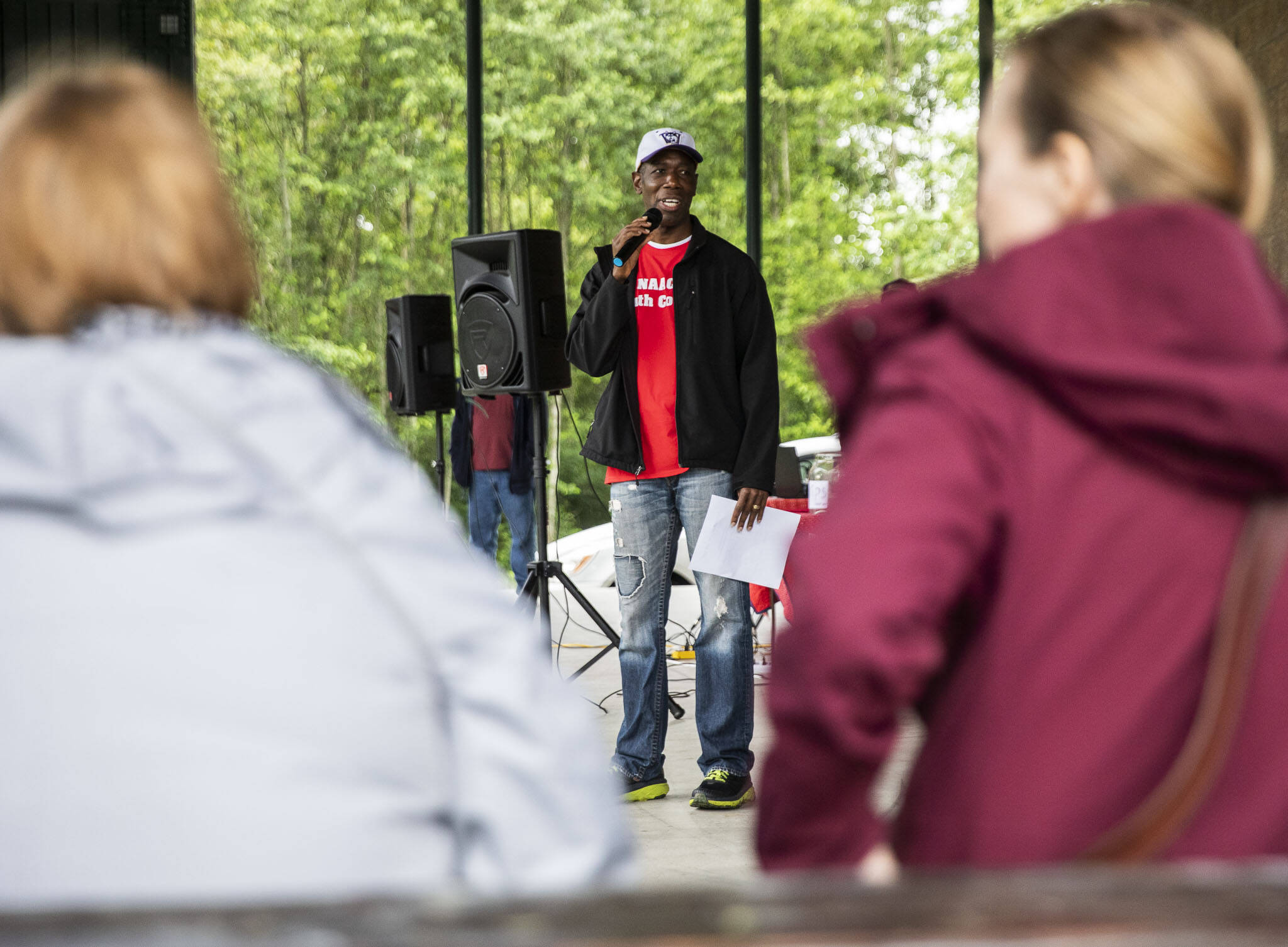 The lead organizer of the Snohomish Juneteenth celebration, John Agyapong, speaks to those gathered Saturday at Willis D. Tucker Park in Snohomish. (Olivia Vanni / The Herald)
