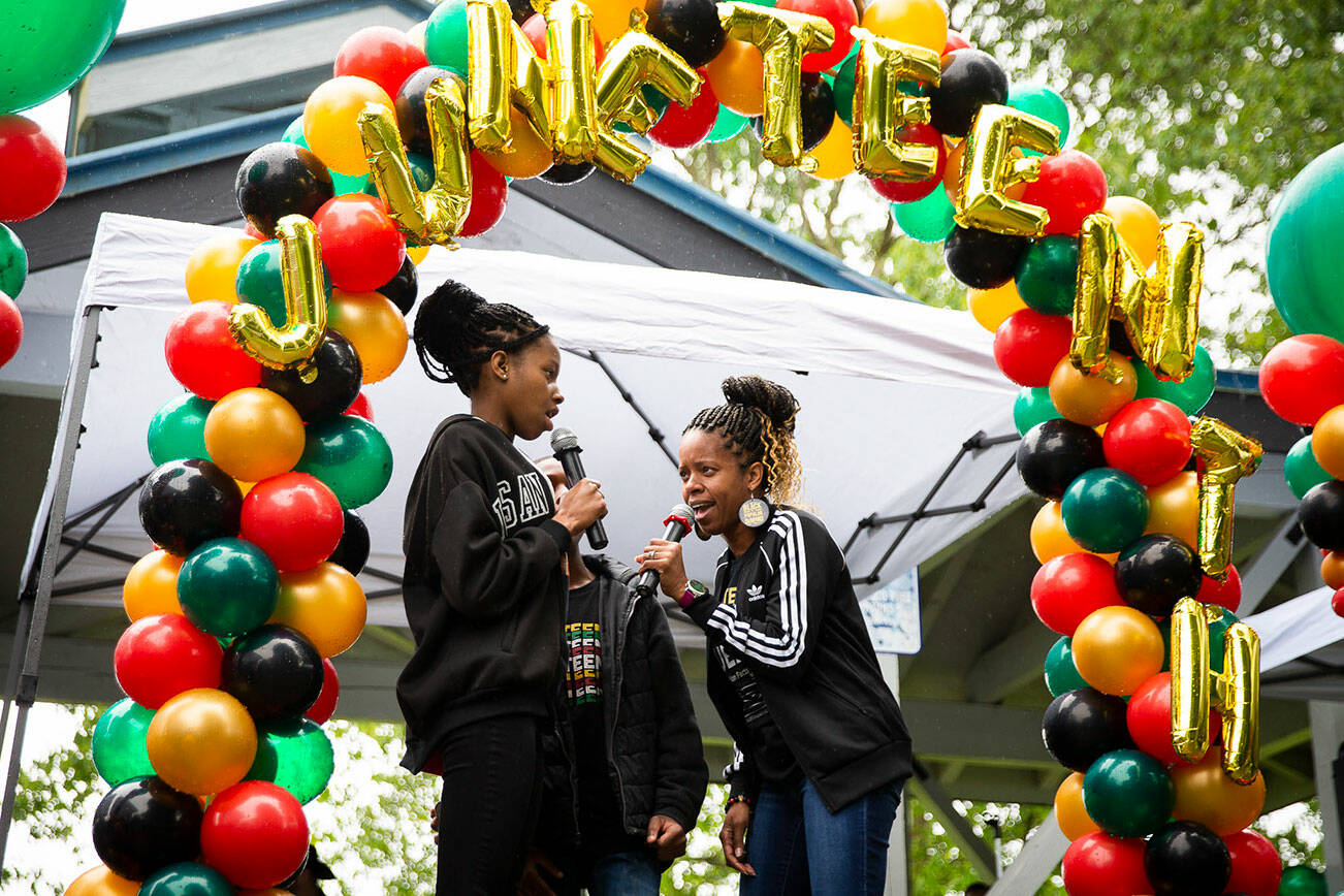 Junelle Lewis, right, daughter Tamara Grigsby and son Jayden Hill sing “Lift Every Voice and Sing” during Monroe’s Juneteenth celebration on Saturday, June 18, 2022. (Olivia Vanni / The Herald)