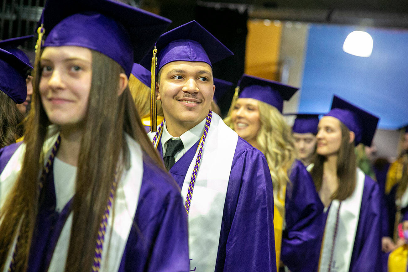 Students line up and wait to begin their procession during Lake Stevens High School’s 2022 commencement ceremony Tuesday, June 7, 2022, at Angel of the Winds Arena in Everett, Washington. (Ryan Berry / The Herald)