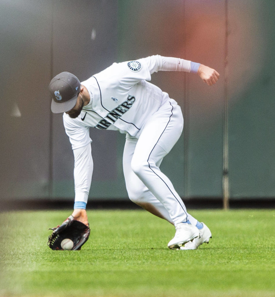 Mariners’ Jesse Winker fields the ball in the outfield during the game against the Angels on Sunday, June 19, 2022 in Seattle, Washington. (Olivia Vanni / The Herald)
