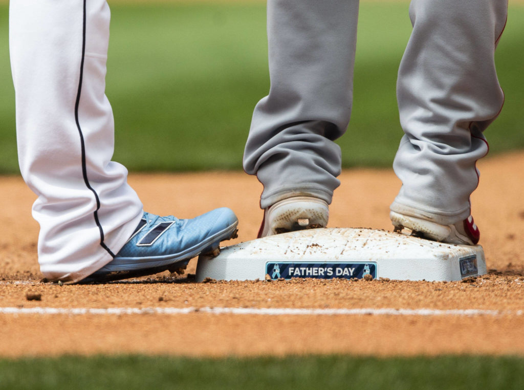 Father’s Day decals are visible on the first base at T-Mobile Park during the game against the Angels on Sunday, June 19, 2022 in Seattle, Washington. (Olivia Vanni / The Herald)
