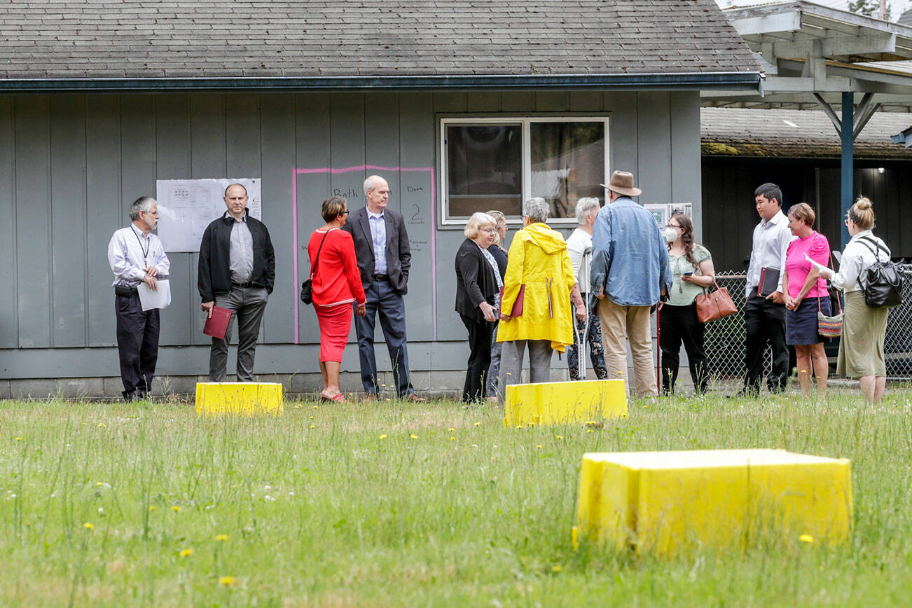 Officials tour the future site of the Faith Family Village Wednesday morning at Faith Lutheran Church in Everett, Washington on June 29, 2022. (Kevin Clark / The Herald)