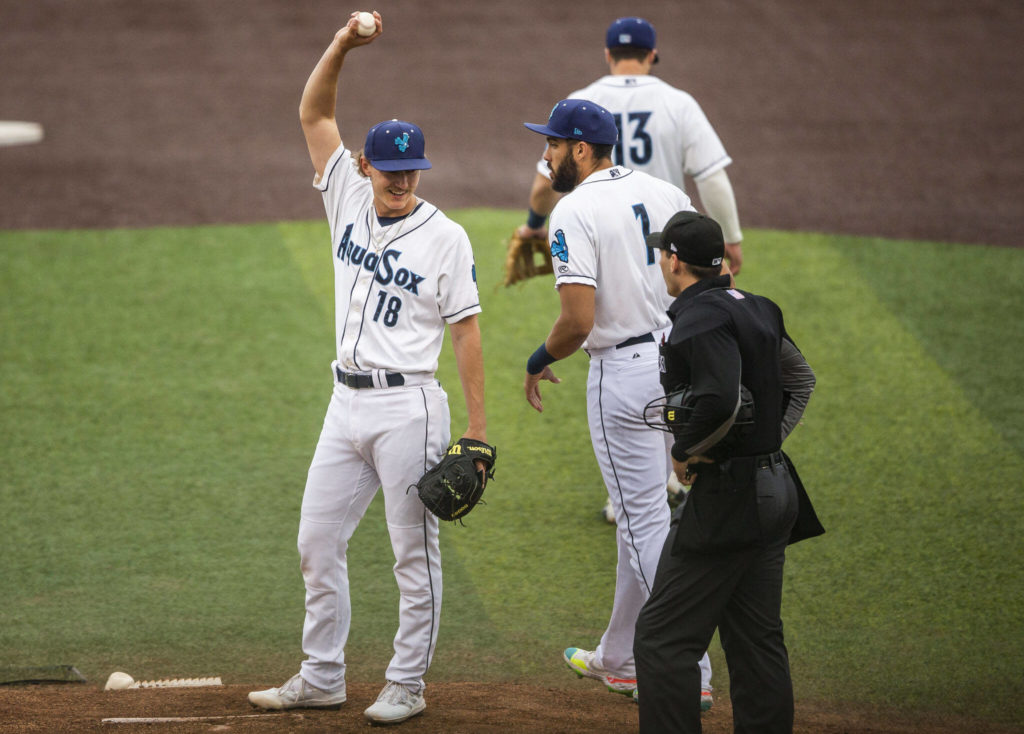 Bryce Miller stretches and talks with the umpire after being struck in the arm by a hit during a game against the Tri-City Dust Devils on June 15 in Everett. (Olivia Vanni / The Herald)
