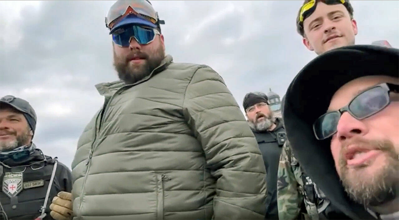 Daniel Scott (center, in green jacket) and Eddie Block (bottom right) are shown in a video before the Proud Boys and other rioters stormed the U.S. Capitol building on Jan. 6 in Washington, D.C.