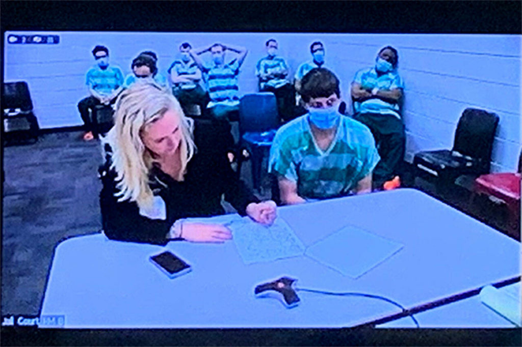 Shayne Baker, 25, alongside public defender Cassie Trueblood at a first court appearance Wednesday. (Jake Goldstein-Street / The Herald) 
