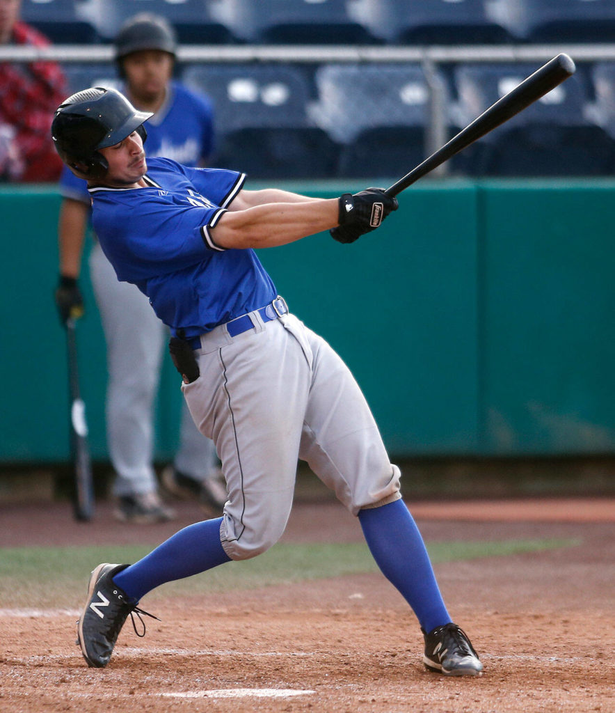 The Everett Merchants’ Aaron Clogston, from Monroe, puts the ball in play during a game against the Seattle Blackfins on Wednesday, June 22, 2022, at Funko Field in Everett, Washington. (Ryan Berry / The Herald)
