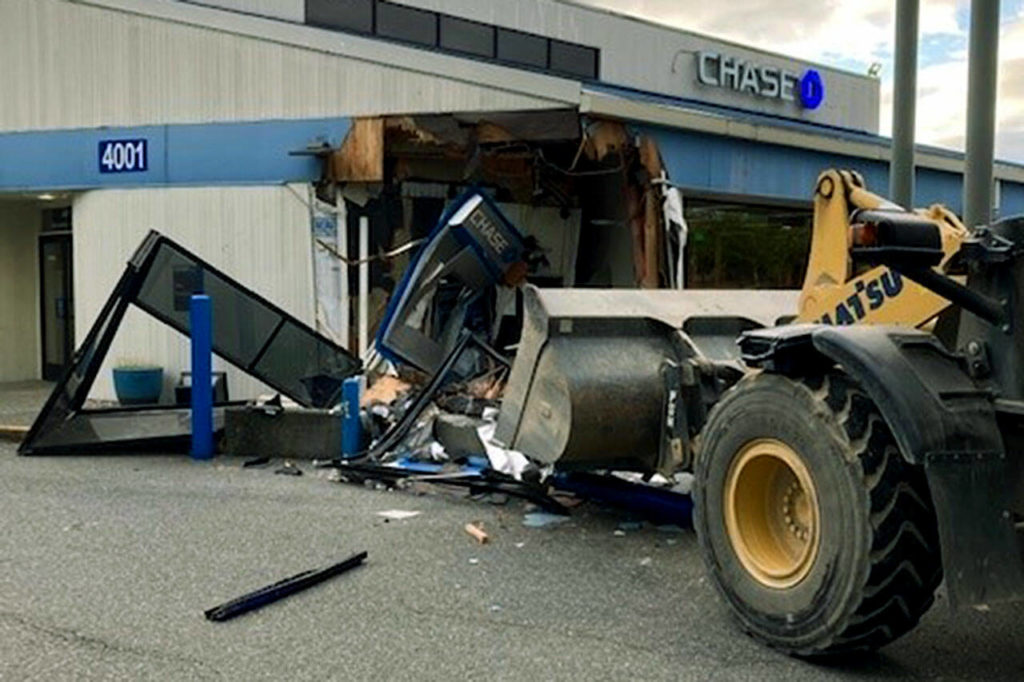A man crashed a large construction equipment front-loader into the Chase Bank building at 4001 Alderwood Mall Boulevard in Lynnwood on Wednesday. (Lynnwood Police Department)
