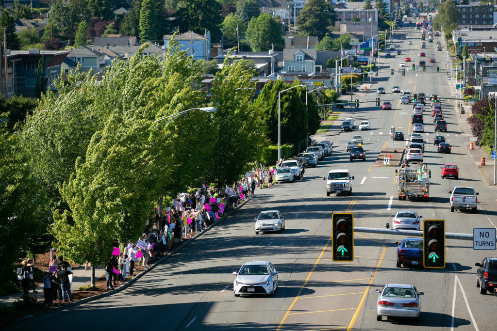 A quickly growing crowd of demonstrators stands along Broadway during a protest against the Supreme Court’s decision to overturn Roe v. Wade on Friday in Everett, Washington. The number of protesters would later reach about 200 people. (Ryan Berry / The Herald)
