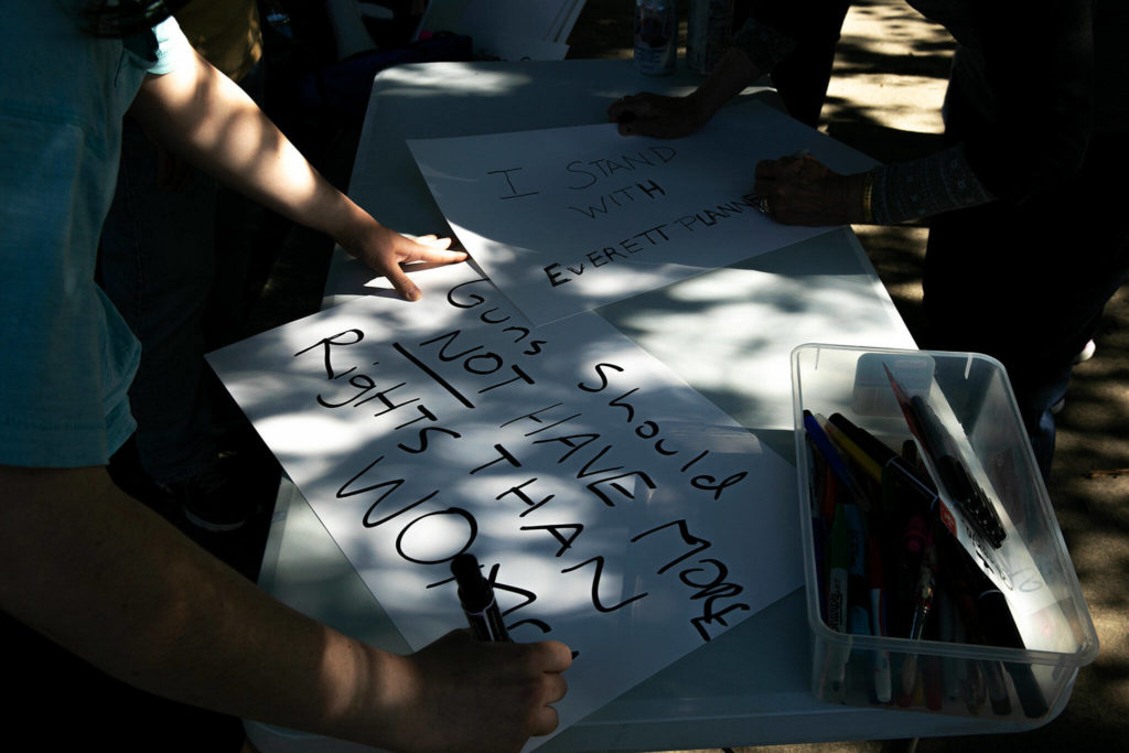 People make signs to hold during a protest against the Supreme Court’s decision to overturn Roe v. Wade on Friday along Broadway in Everett, Washington. (Ryan Berry / The Herald)
