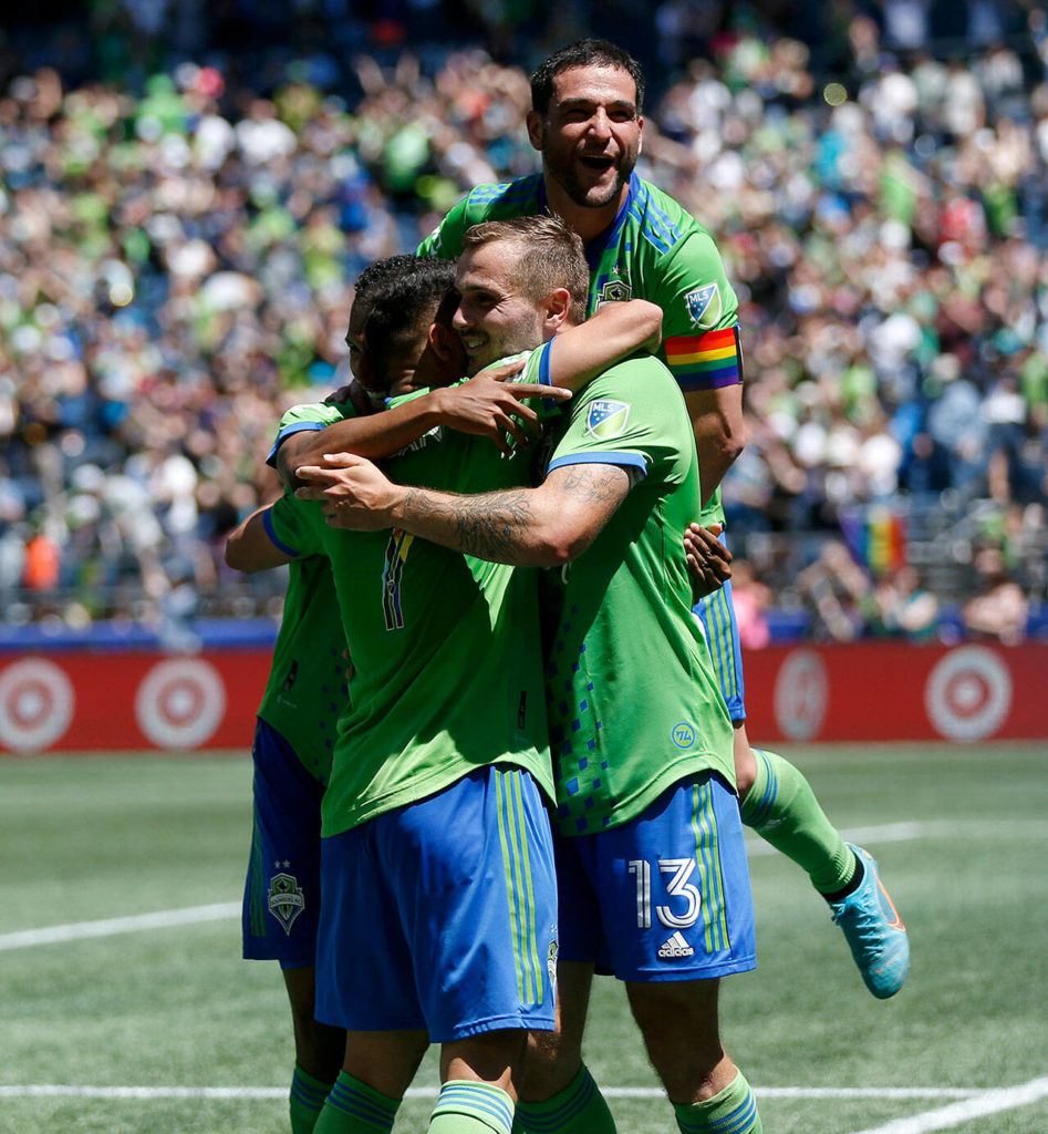 The Seattle Sounders celebrate a third and final goal against Sporting KC on Saturday, June 25, 2022, at Lumen Field in Seattle, Washington. (Ryan Berry / The Herald)
