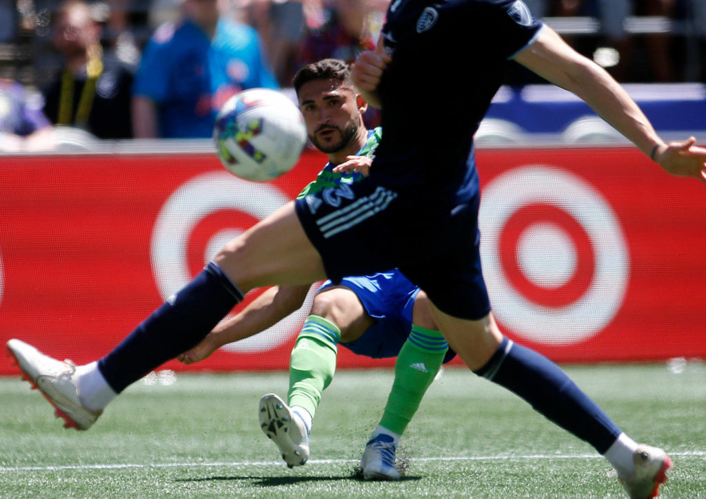 The Seattle Sounders’ Nicolás Lodeiro centers the ball against Sporting KC on Saturday, June 25, 2022, at Lumen Field in Seattle, Washington. (Ryan Berry / The Herald)
