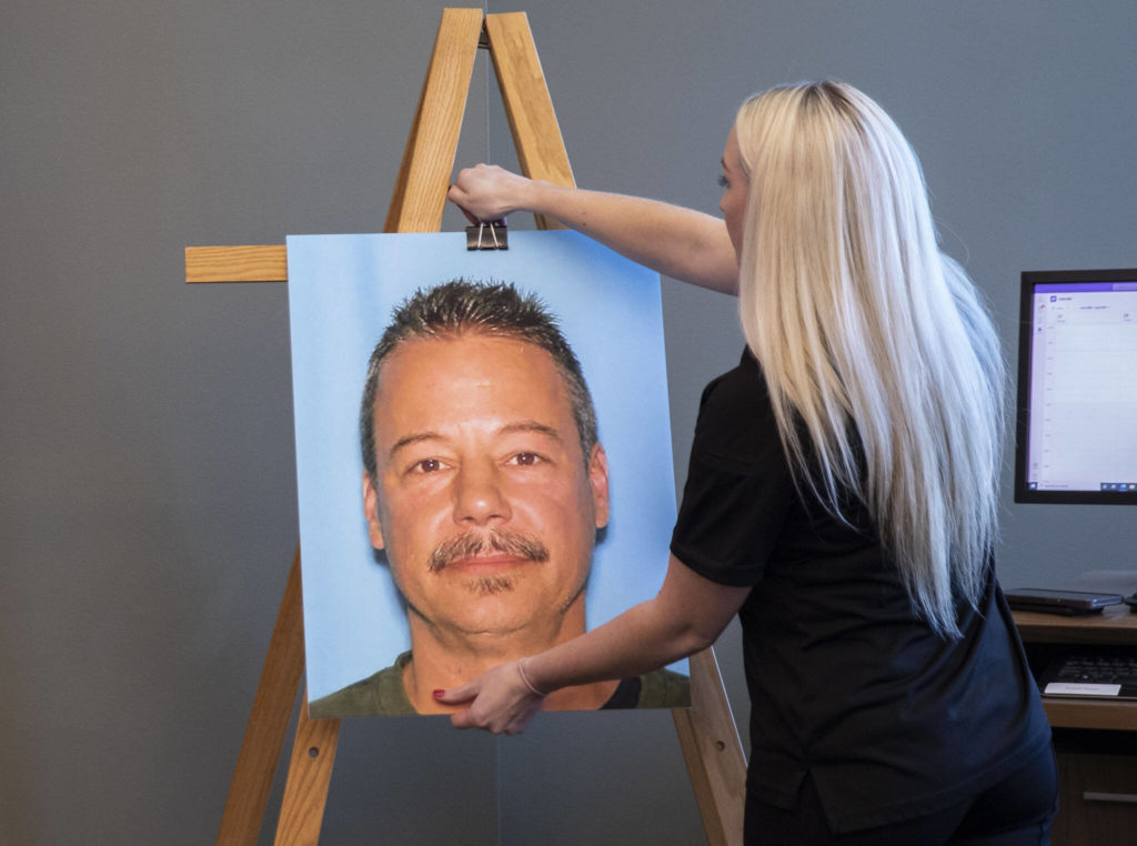 A photo of Robert Anthony Brooks is placed on display during the Snohomish County Sheriff’s Office press conference announcing him as a suspect in Michelle Koski’s 1990 cold case on Thursday in Everett. (Olivia Vanni / The Herald)
