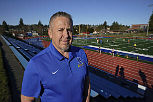 Joe Kennedy, a former assistant football coach at Bremerton High School in Bremerton, Wash., poses for a photo March 9, 2022, at the schools football field. After losing his coaching job for refusing to stop kneeling in prayer with players and spectators on the field immediately after football games, Kennedy took his arguments before the U.S. Supreme Court. On Monday, the court found 6-3 in his favor. (Ted S. Warren / Associated Press)