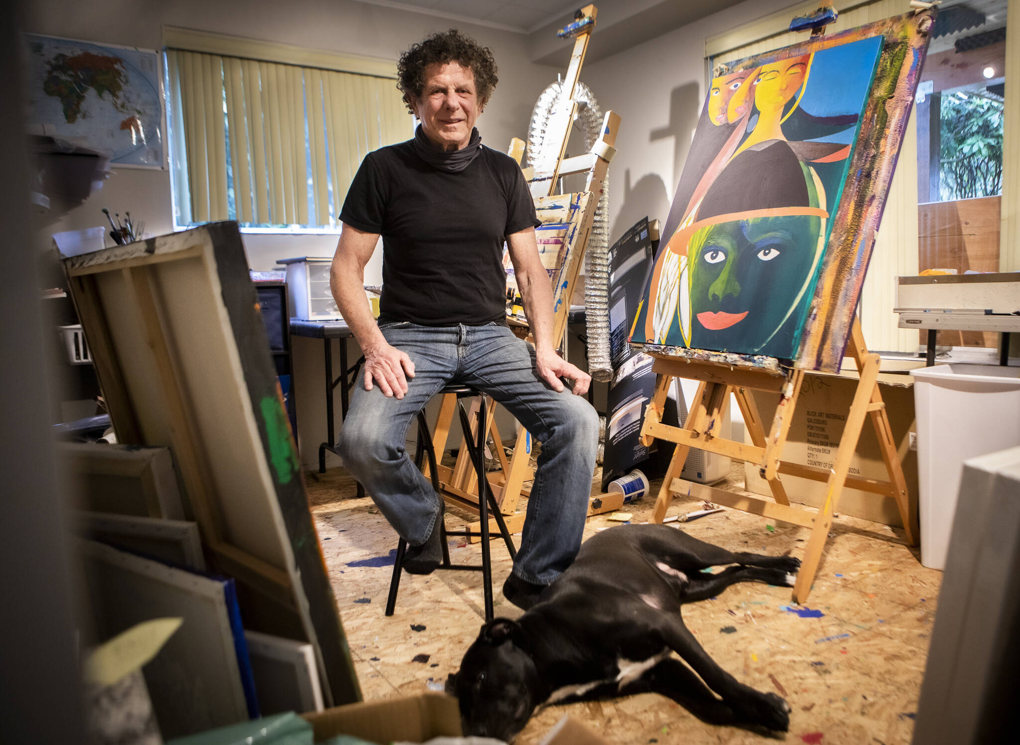 Lee Oskar and his dog Tex inside his art studio in his Everett home. (Olivia Vanni / The Herald)
