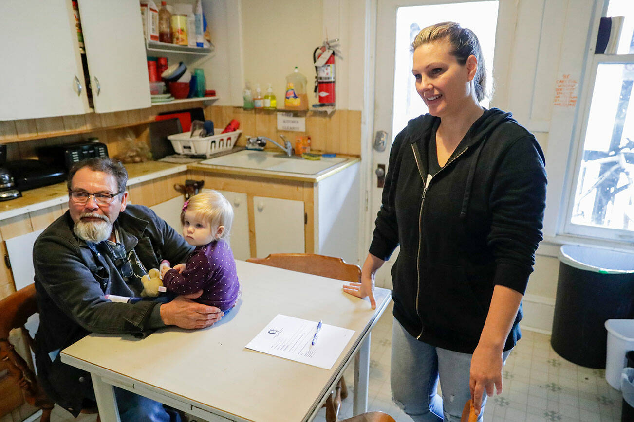 Mike Kersey with Aiya Moore, daughter of Christina Anderson, right, talk about the condition of Nick’s Place in Everett, Washington on June 17, 2022.  (Kevin Clark / The Herald)