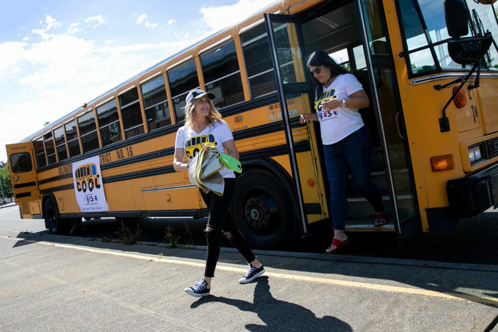 Teachers get off the Cool Bus to prepare for their next stop on July 6, at Presidents Elementary School in Arlington. (Ryan Berry / The Herald)
