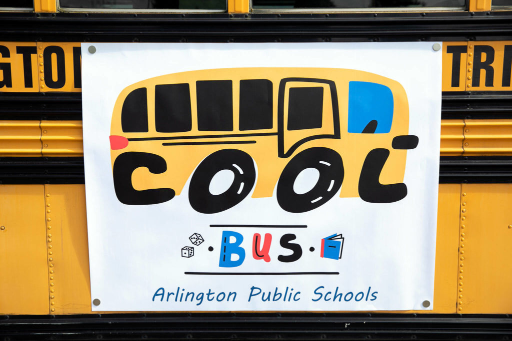 The Cool Bus logo hangs on the side of the bus on July 6, at Presidents Elementary School in Arlington. (Ryan Berry / The Herald)
