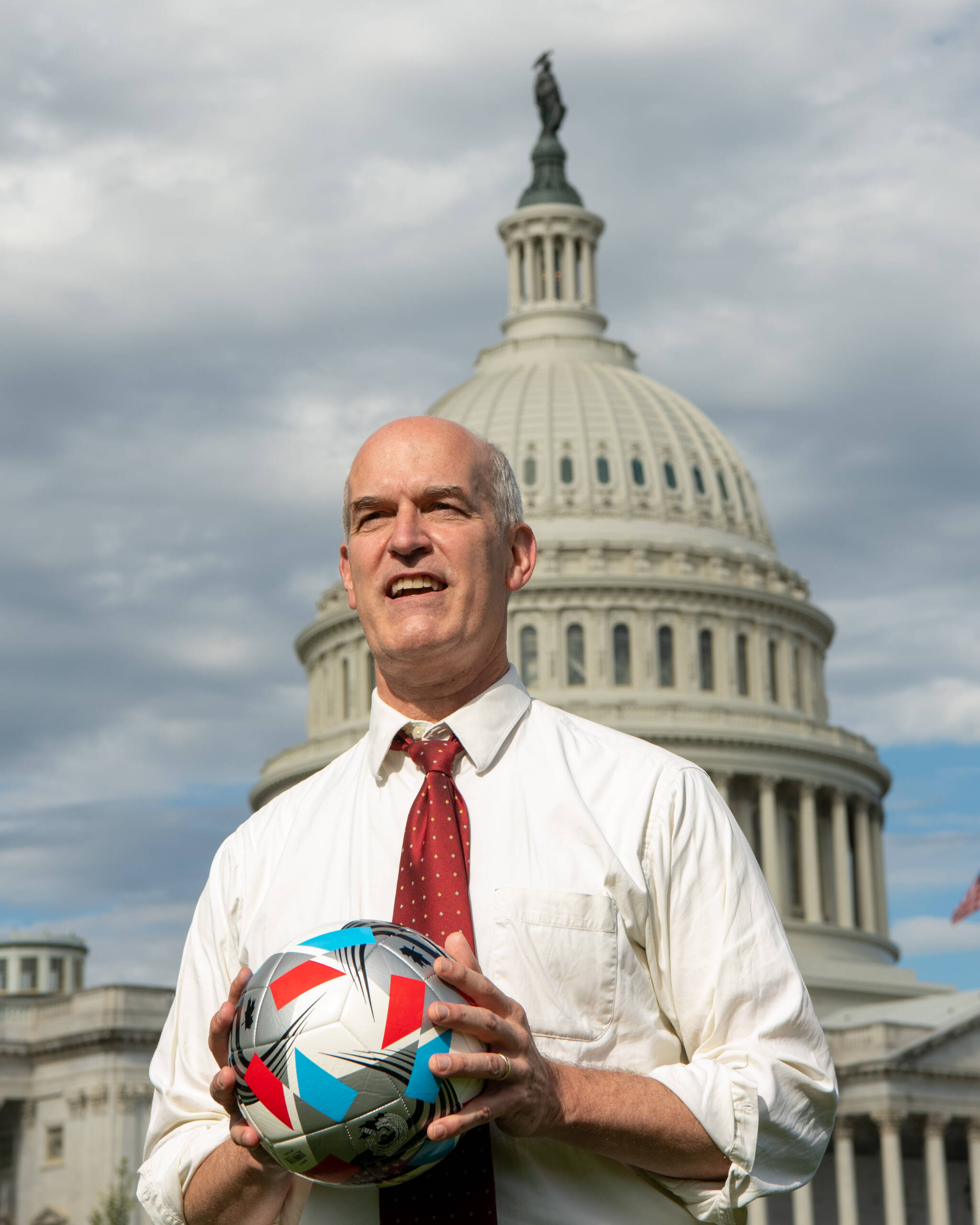 U.S. Rep. Rick Larsen of Everett poses with a soccer ball in front of the U.S. capitol building in Washington, D.C. (Provided photo)