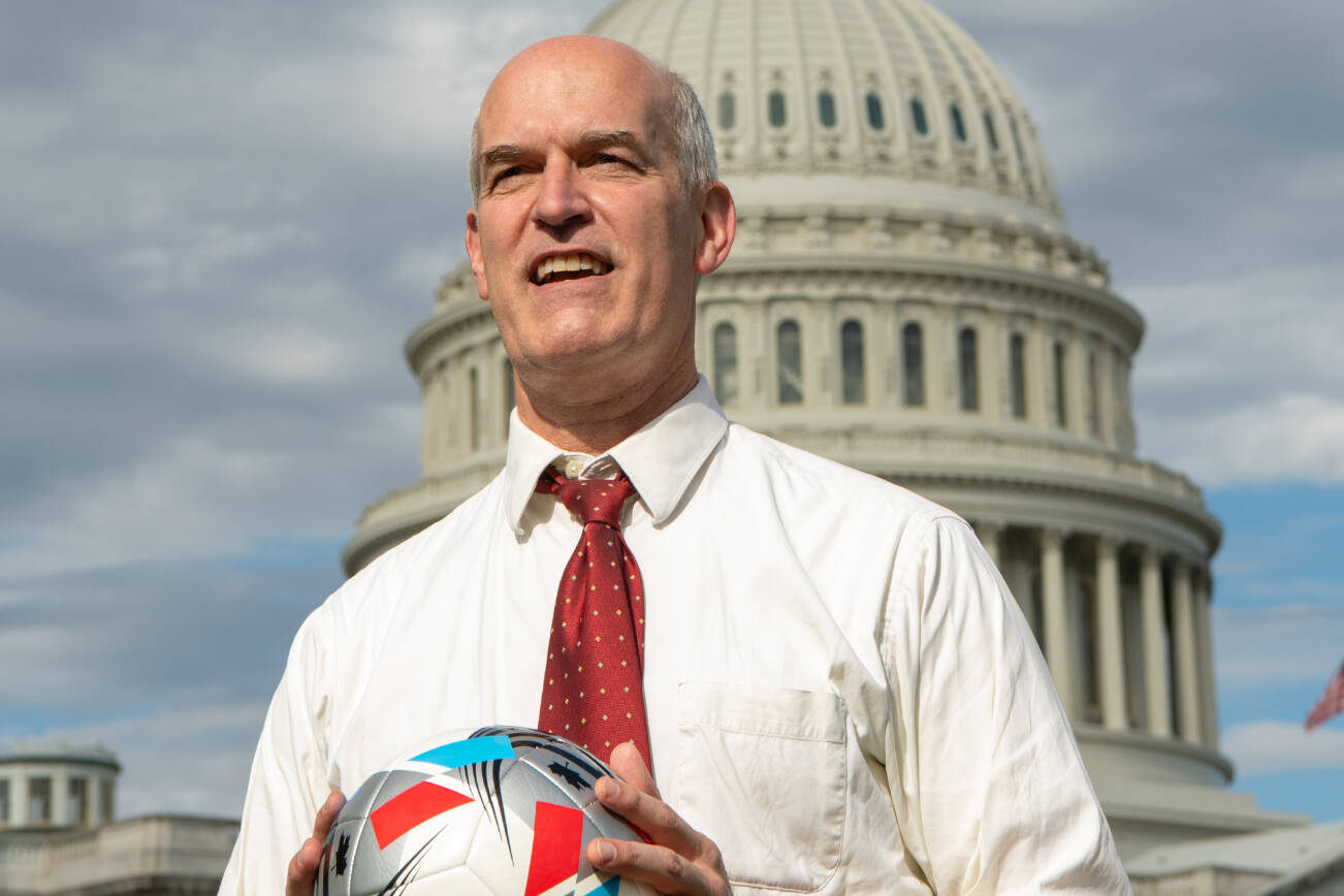 U.S. Rep. Rick Larsen of Everett poses with a soccer ball in front of the U.S. capitol building in Washington, D.C.. (Provided photo)