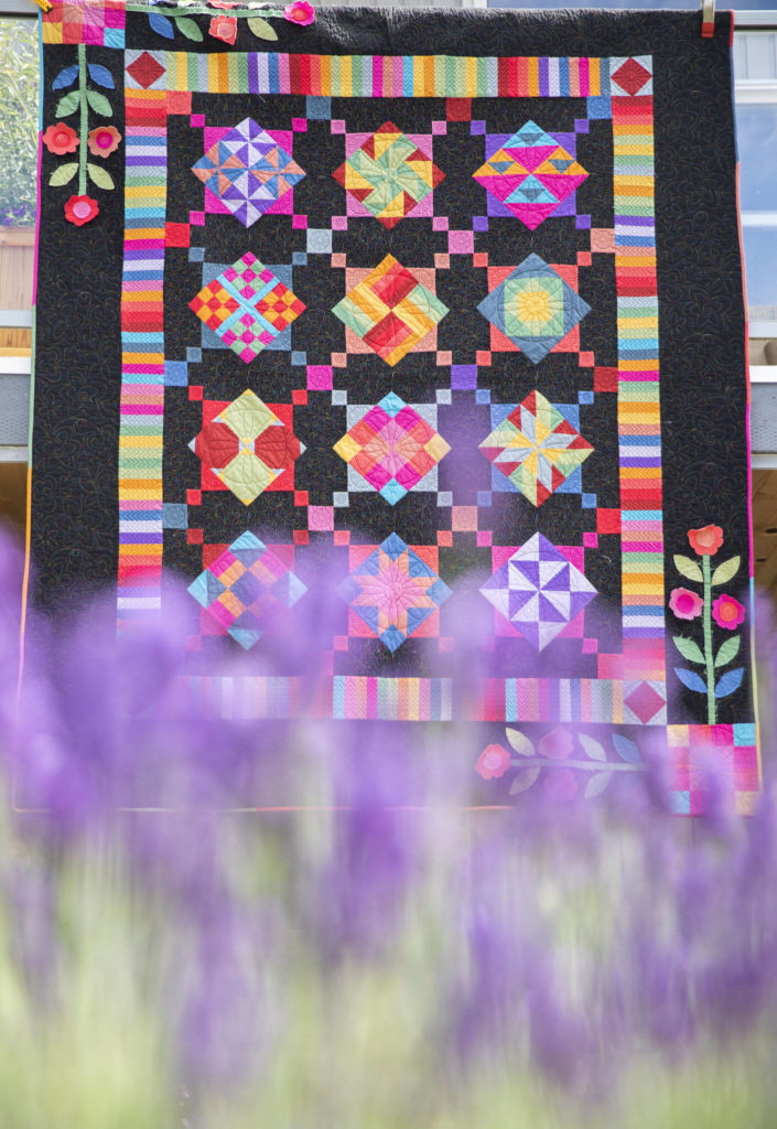 A raffle quilt titled “Amish with a Twist” is on display in the garden of a Mukilteo Garden Quilt Tour. The tour is July 16 and 17. (Olivia Vanni / The Herald)
