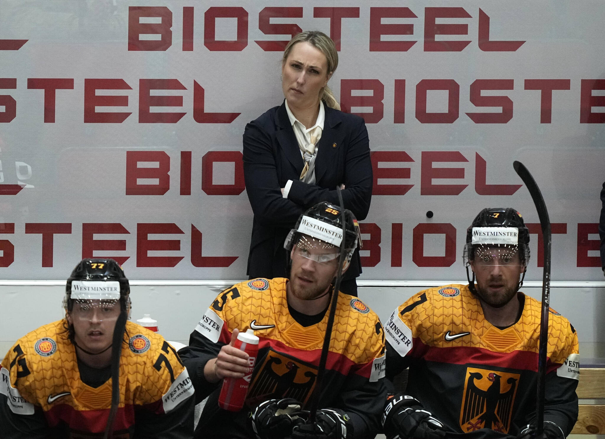 Germany assistant coach Jessica Campbell stands behind players on the bench during a group A Hockey World Championship match between France and Germany on May 16, 2022, in Helsinki, Finland. (AP Photo/Martin Meissner)