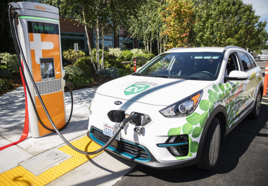 Two EV charging stations are unveiled at a ribbon cutting outside of PUD headquarters on Wednesday, in Everett. (Olivia Vanni / The Herald)
