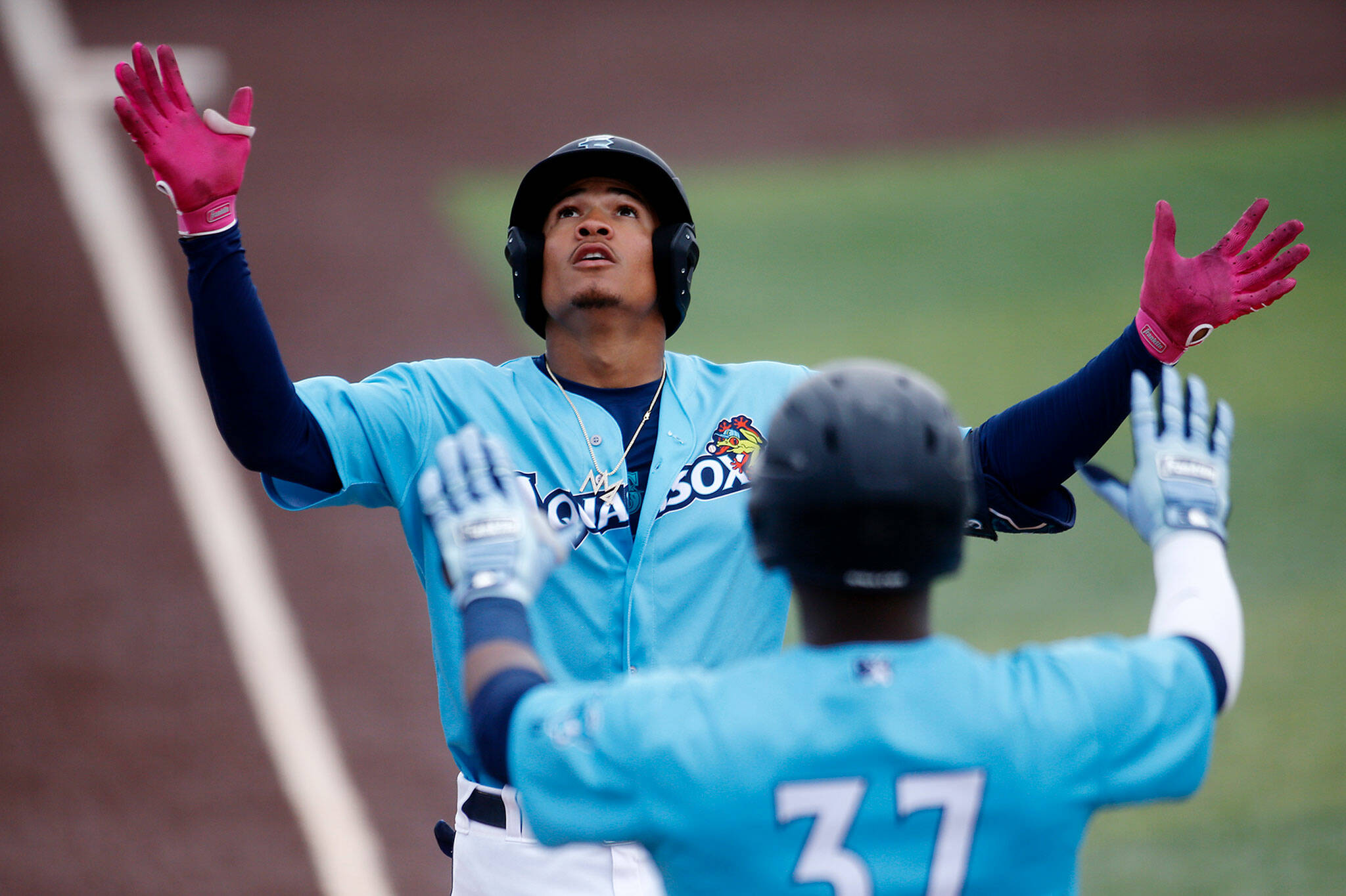 The AquaSox’s Noelvi Marte looks up to the sky while rounding the bases after a long homer to center field during a game against the Vancouver Canadians Wednesday, July 6, 2022, at Funko Field in Everett, Washington. (Ryan Berry / The Herald)