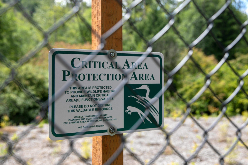 A sign indicates protected land on Thursday at a new protected habitat south of Mill Creek. (Ryan Berry / The Herald)
